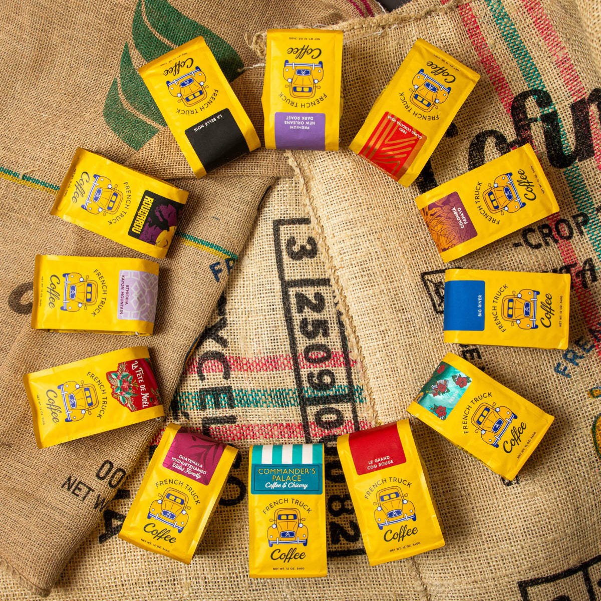 Yellow French Truck coffee packages with colorful labels on a burlap background